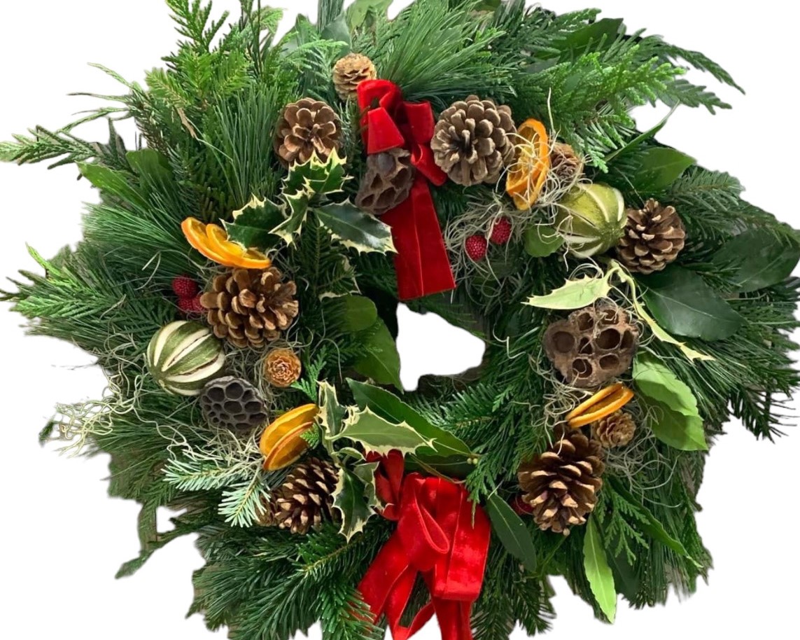 Christmas wreath with pinecones, orange slices and red ribbon