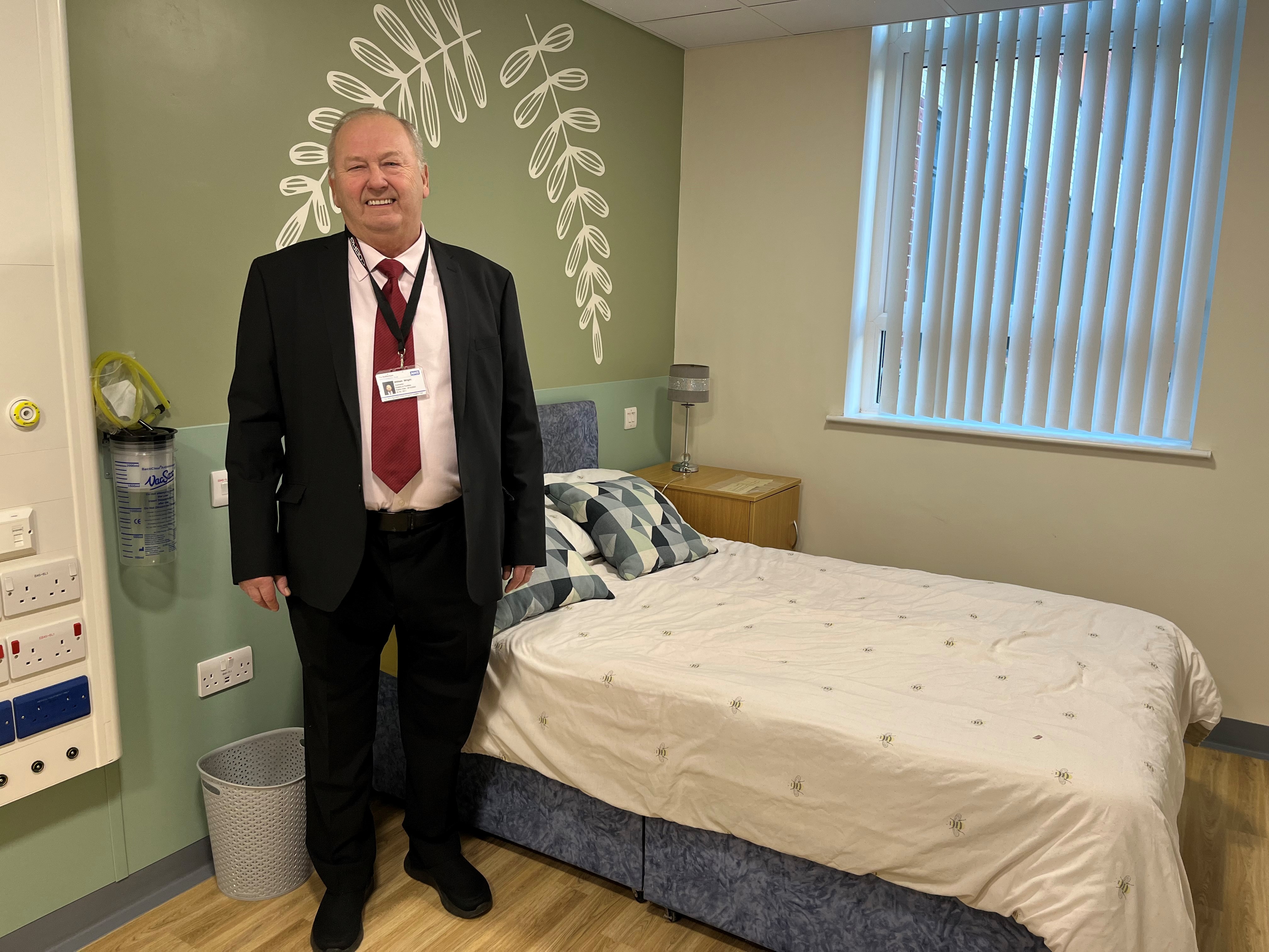 A person in a suit in one of the parent bedrooms on the neonatal unit