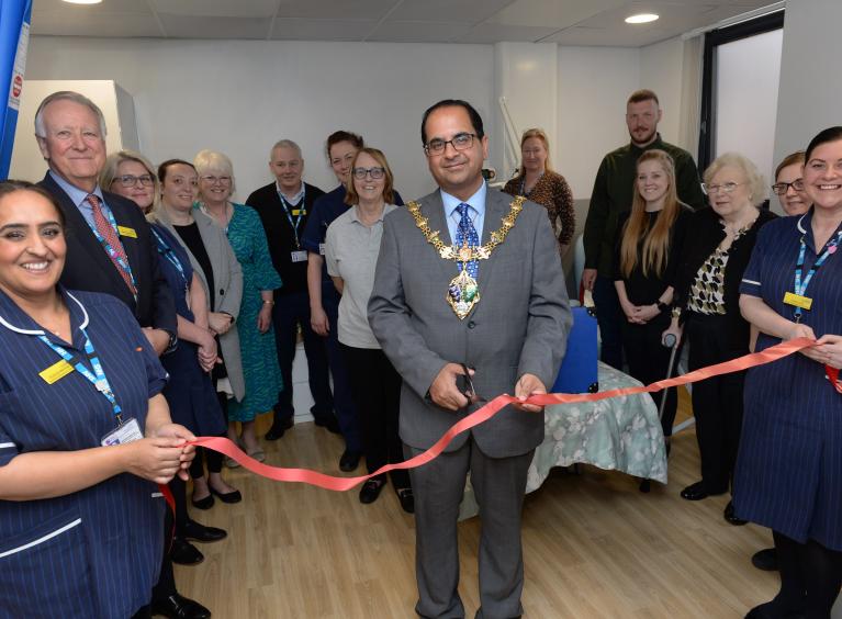 Tajamal Khan cutting the ribbon to open the Snowdrop Suite