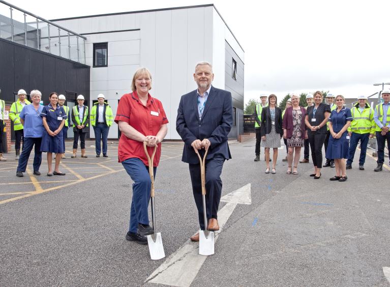 Clinical, Trust and construction colleagues posing with spades at the ground breaking ceremony