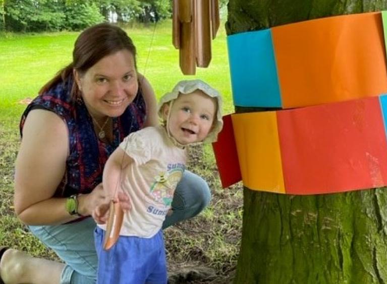 Mother and daughter smiling while at Park Baby