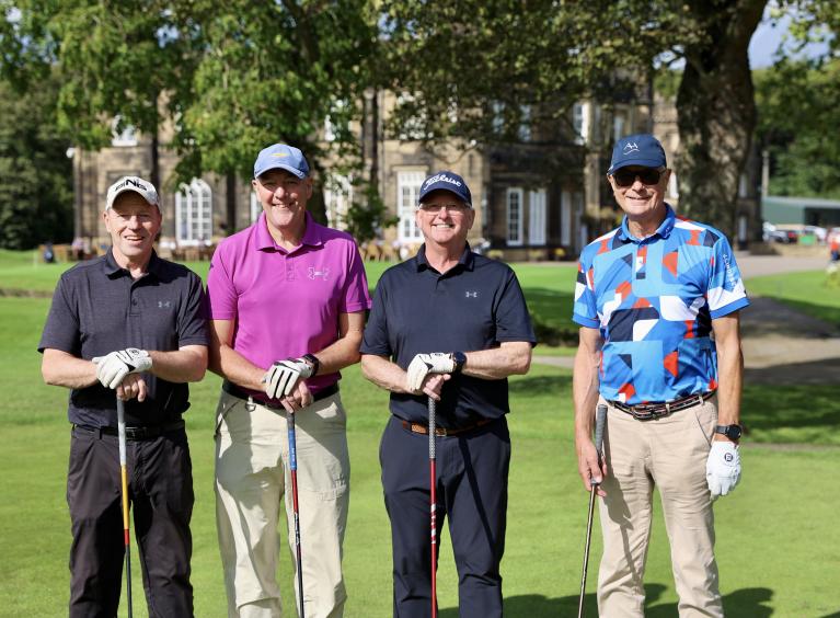 'Team Hallows 2' - four people holding golf clubs and wearing golf attire, stood in front of Rotherham Golf Club