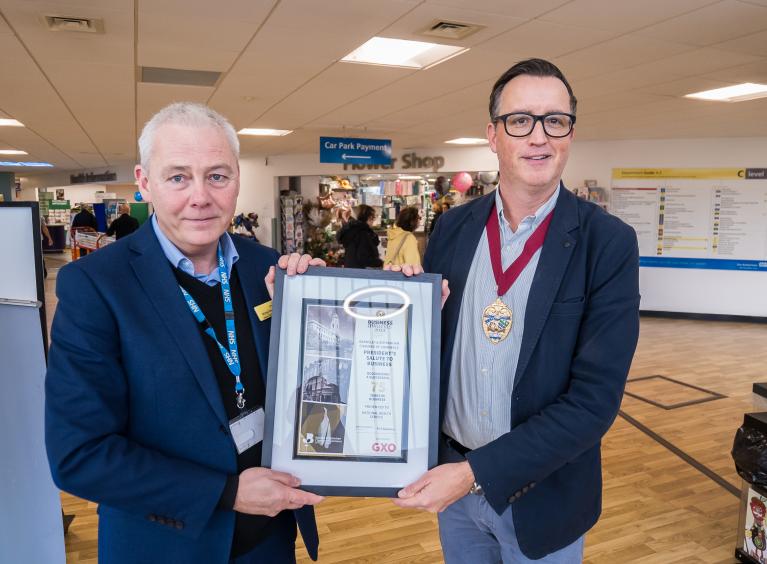 Michael Wright and Matthew Stephens in the main entrance of Rotherham Hospital, holding the 'President's salute to business' certificate.