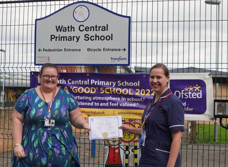 Amy Shaw (Assistant Headteacher  at Wath Central Primary) and Hannah Lee (Asthma Specialist Nurse) holding the school's Asthma Friendly initiative accreditation certificate.