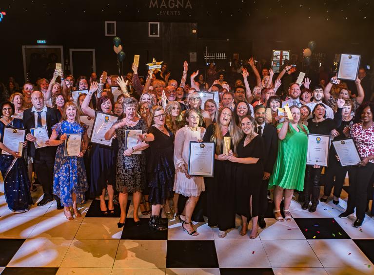 Winners of the 2024 Proud Awards holding their certificates and trophies