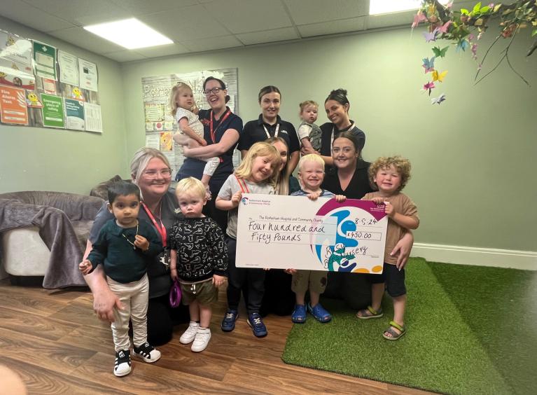 Youngsters and staff from Busy Bees Nursery celebrating their fundraising for the Rotherham Hospital and Community Charity’s Tiny Toes appeal.