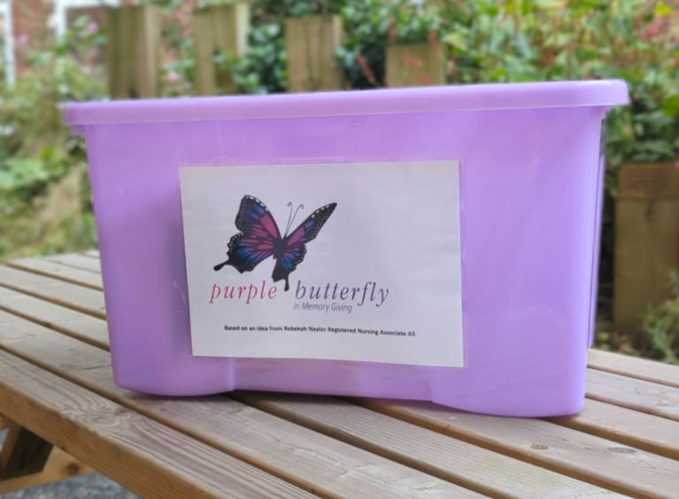 The image shows an example of a Purple Butterfly in Memory Giving model of care box.