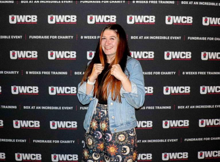 Megan in stood with her arms in a boxing pose.