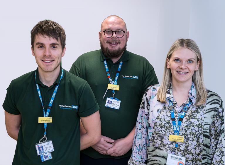 Three members of staff pose for a photo