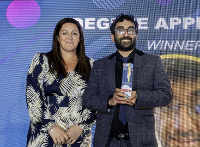 Hashim Din is presented with a glass trophy