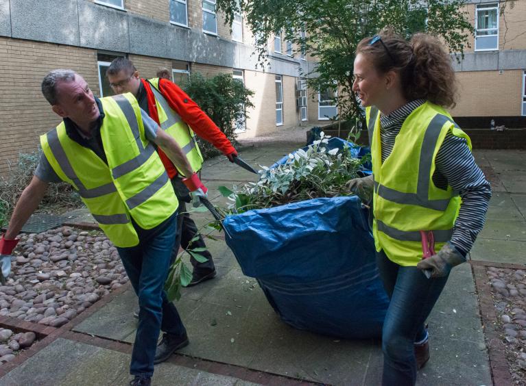 A group of corporate volunteers doing garden work at the hospital