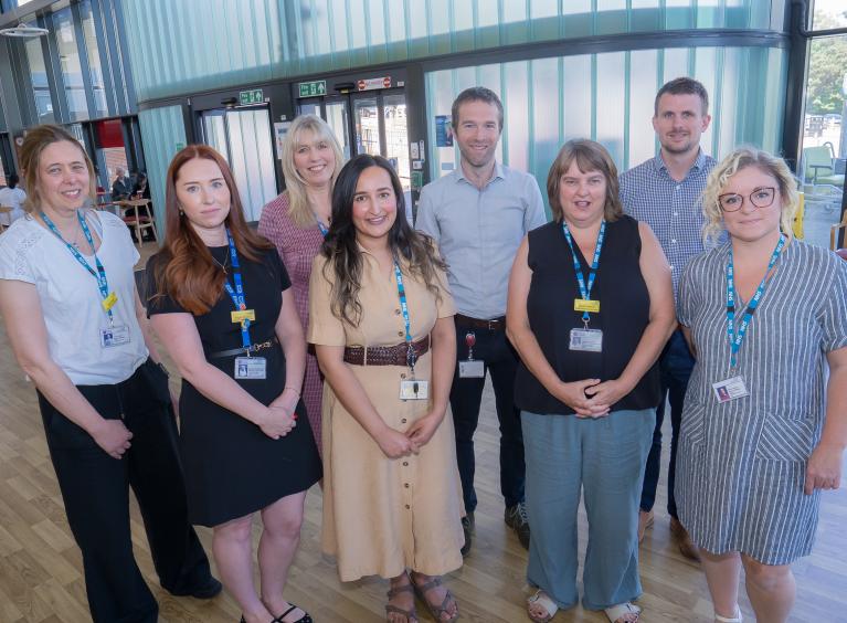 Members of the Medical HR team and Care Group 1 pose in the main entrance of Rotherham Hospital