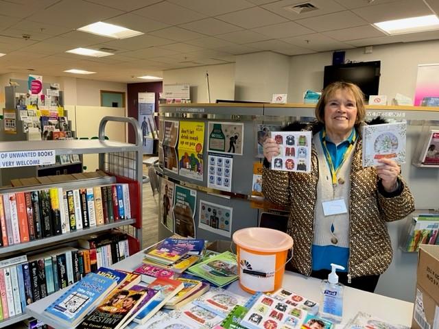 Volunteer selling books to raise money for the charity