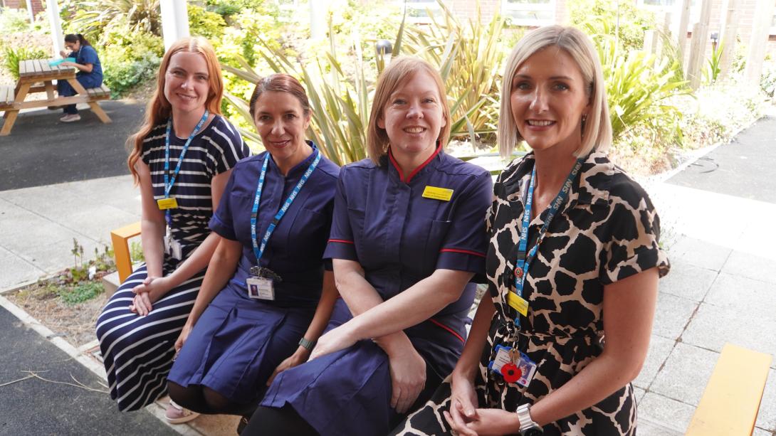 Four nurses sat on a bench